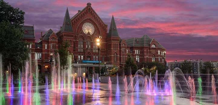 The fountains of Washington Park and the facade of Music Hall at night
